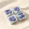 Set of four handmade shell tea lights in soft blue wax with ocean-inspired details, scented in Amalfi Bleu