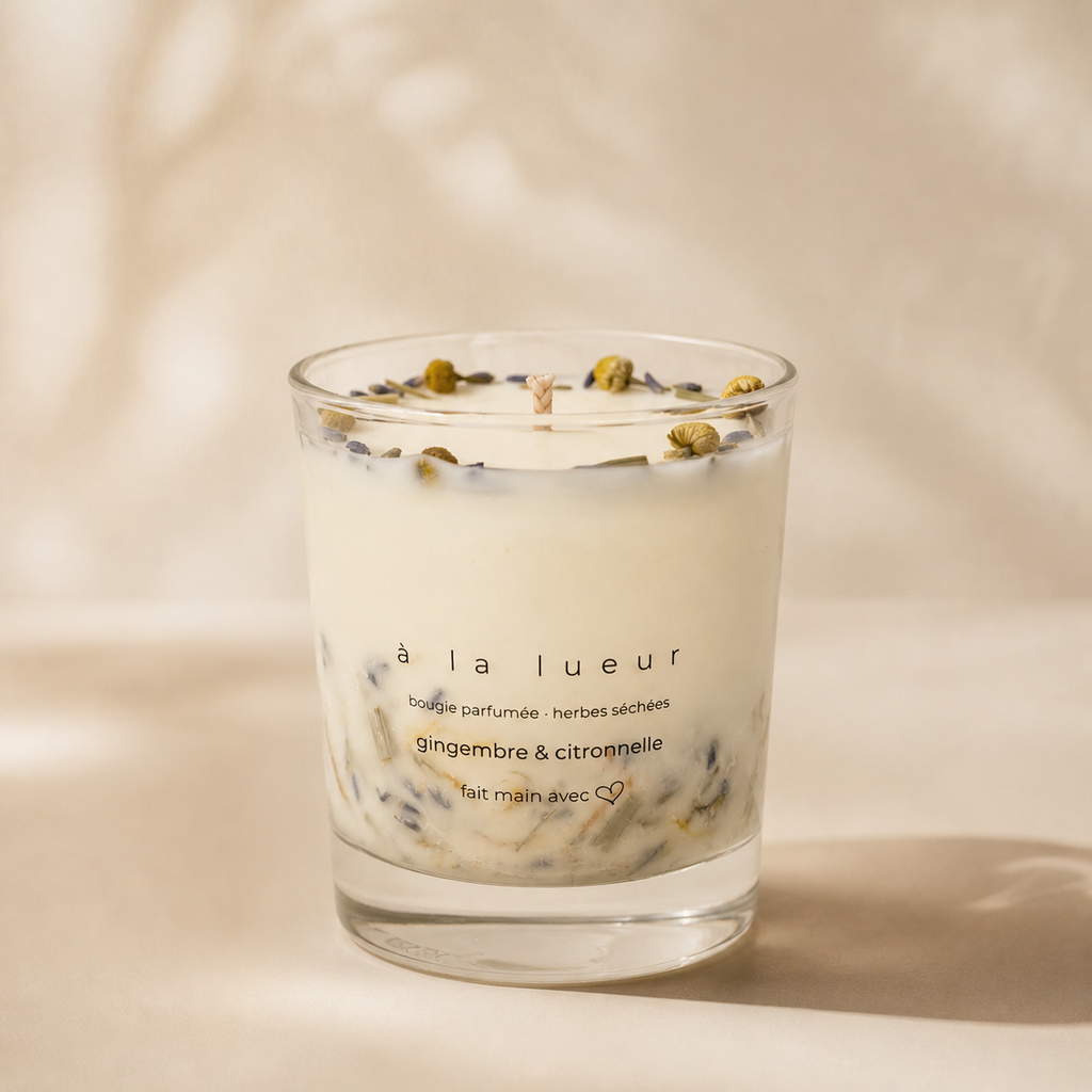 Handmade soy candle with dried herbs in a clear glass vessel from the Everyday Glow collection
