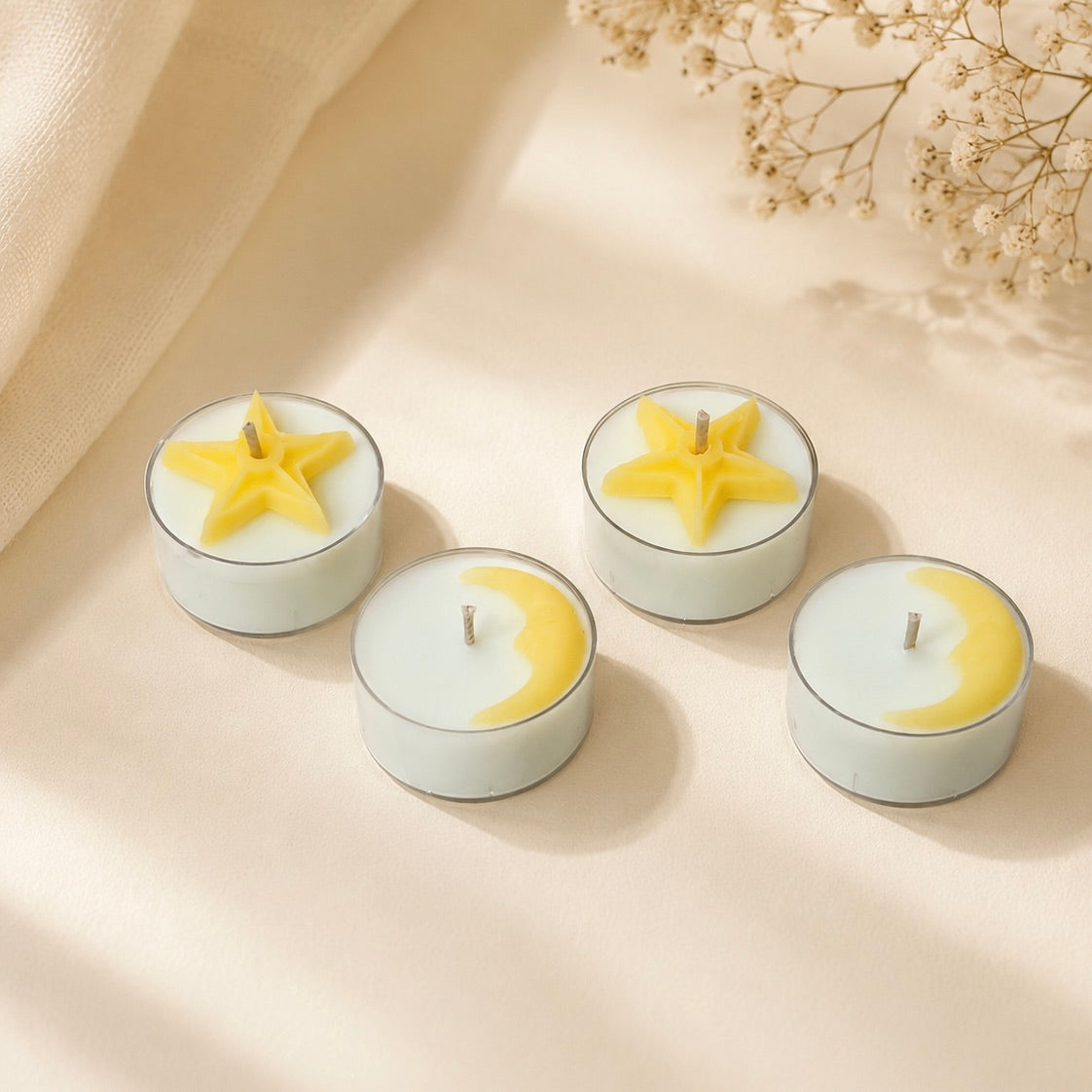 Handmade moon and star tea lights styled in soft natural light with delicate floral background