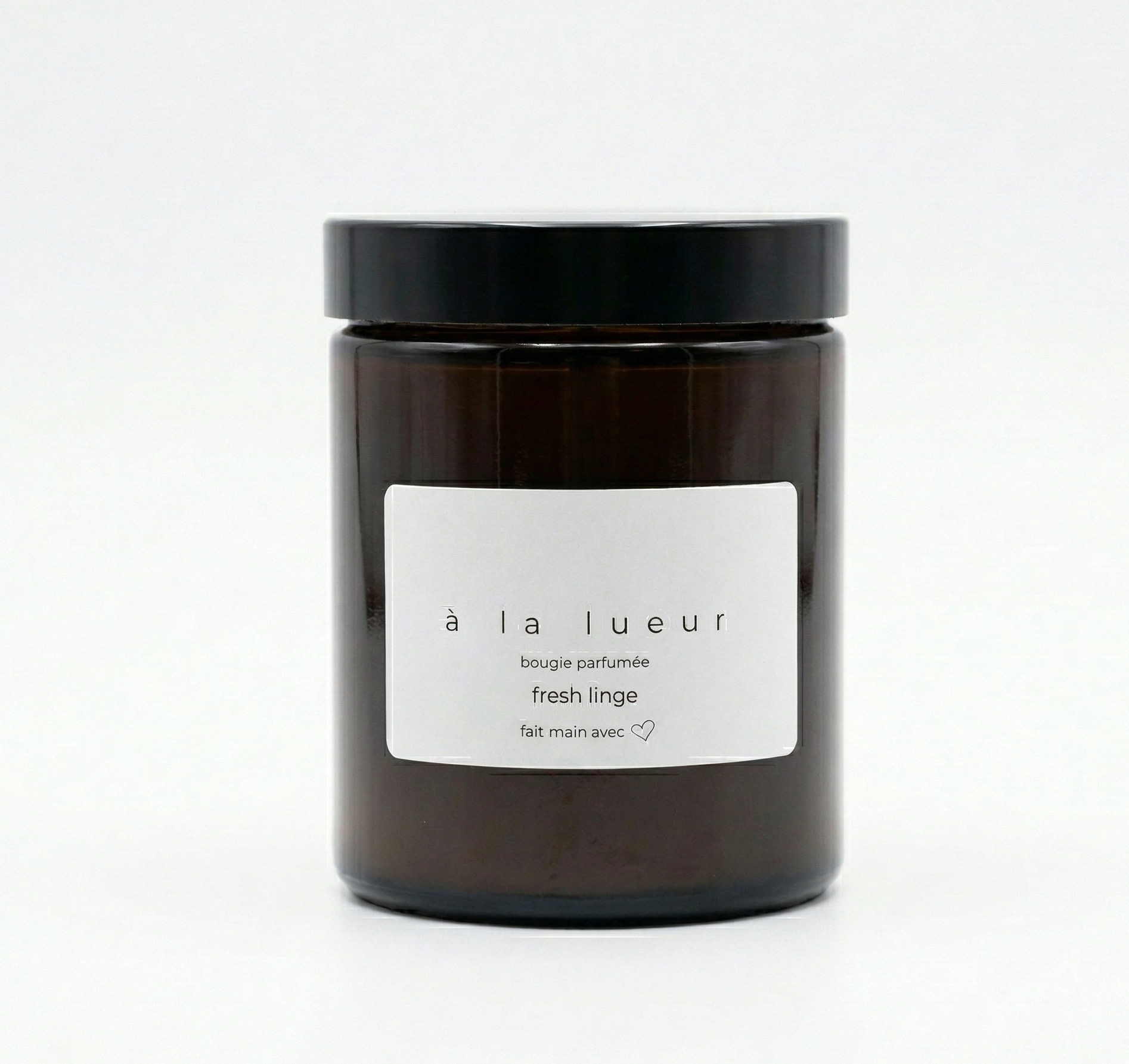 Amber soy candle in amber glass jar with black lid, scented in Fresh Linen