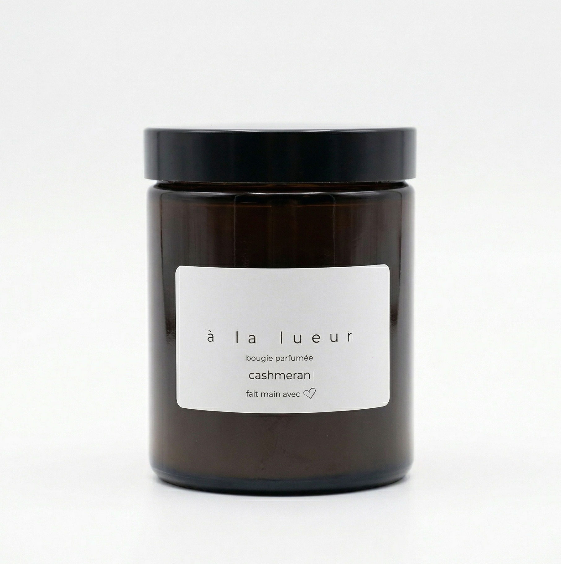Amber soy candle in amber glass jar with black lid, scented with cashmeran