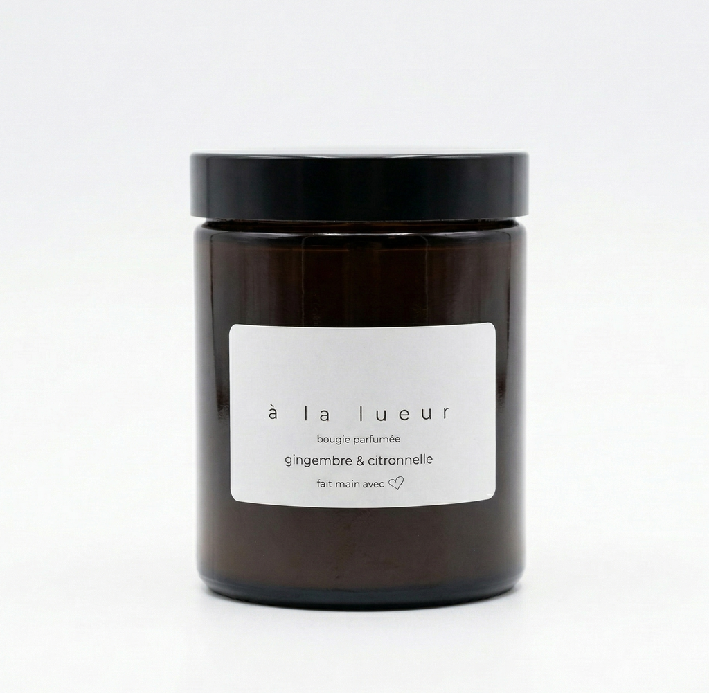 Amber soy candle in amber glass jar with black lid, scented with ginger and lemongrass