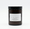 Amber soy candle in amber glass jar with black lid, scented with ginger and lemongrass