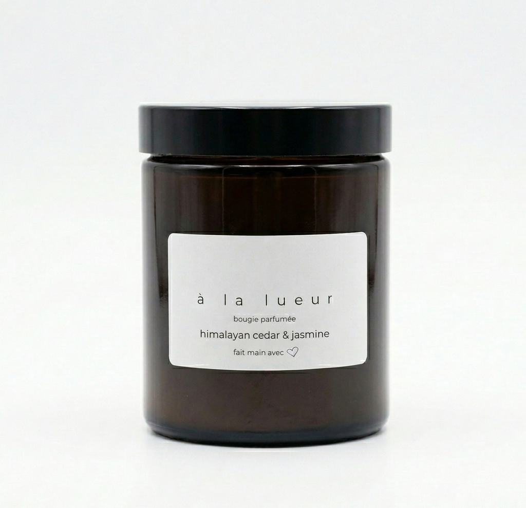 Amber soy candle in amber glass jar with black lid, scented with Himalayan cedar and jasmine