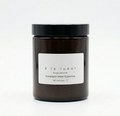 Amber soy candle in amber glass jar with black lid, scented with Himalayan cedar and jasmine